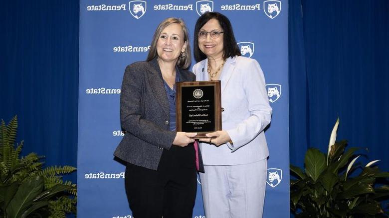 Lolita Paff poses with plaque and Neeli Bendapudi