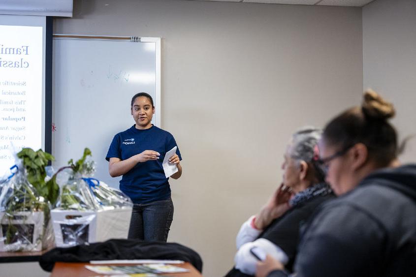 Student presents vegetable research to community members